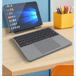 Tablet with keyboard on a desk next to a container of pens
